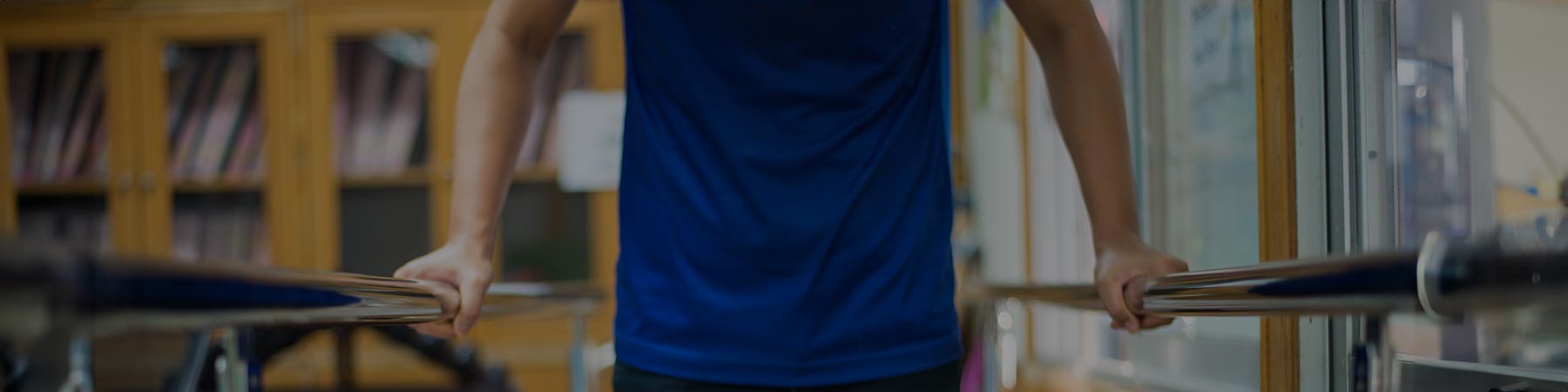 Person using rails for support during therapy program